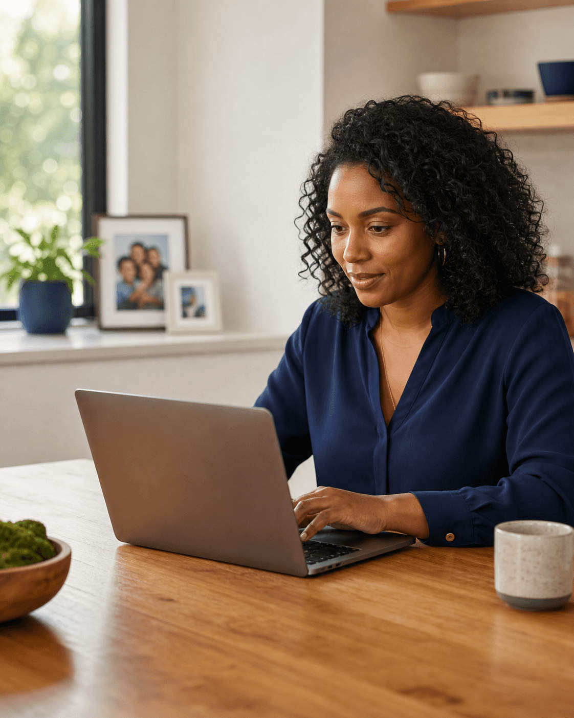 Family administrator organizing digital continuity information on a laptop at home